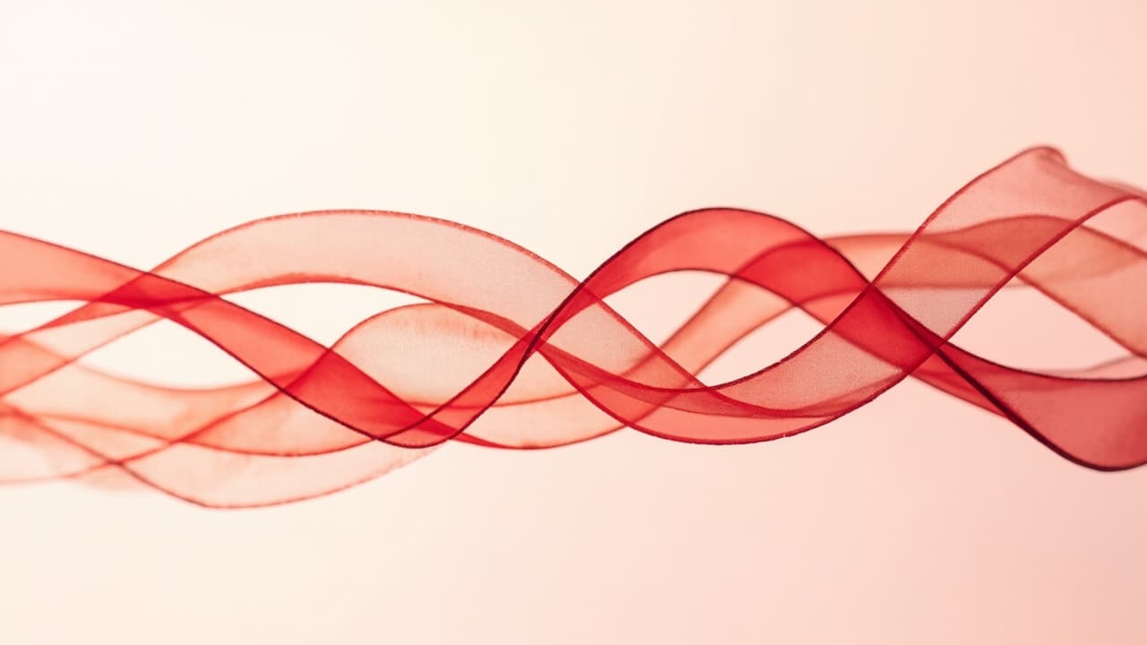 Abstract artwork of two red ribbons of light braided around one another, for the Genetics test category